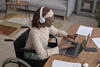 a person sitting at a table using a laptop